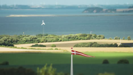 Danish-flag-on-the-rural-coastal-background