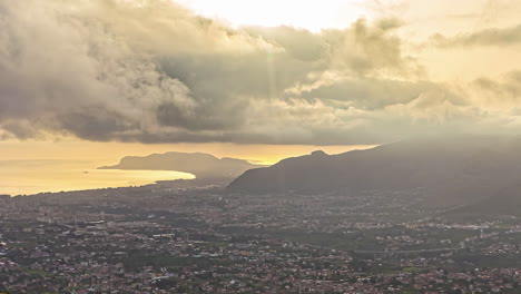 High-angle-shot-over-the-city-of-Sicily,-Italy-on-a-cloudy-evening-in-timelapse