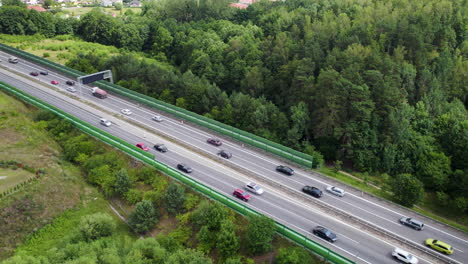 European-four-lane-highway-with-busy-traffic,-aerial-dolly-out