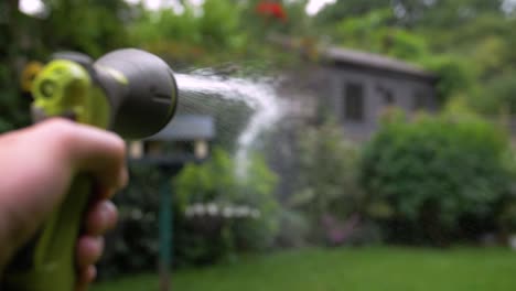 Garden-hose-watering-a-garden-in-slow-motion