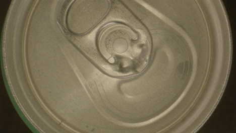 Top-down-zoom-in-of-lid-on-spinning-soda-can