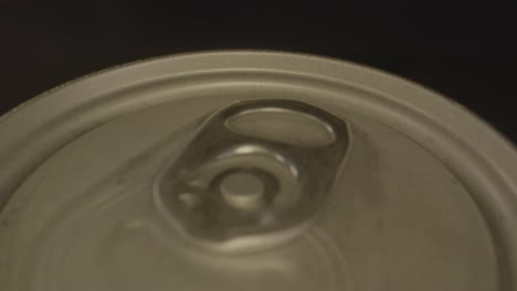 Macro-dolly-out-of-top-of-metal-soda-can-spinning