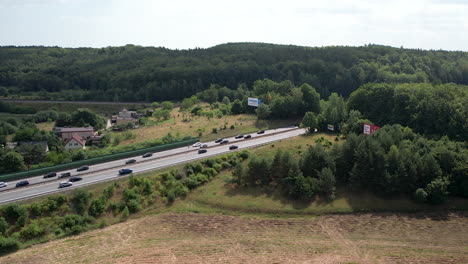 Highway-traffic-in-Europe,-bird's-eye-view-on-a-sunny-day