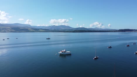 Snowdonia-clear-mountain-range-aerial-reversing-view-sunny-calm-picturesque-Welsh-shimmering-seascape