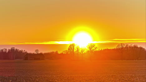 Scenic-View-On-The-Countryside-With-Fiery-And-Vibrant-Sun-Setting-On-The-Horizon-Until-Calm-Sunrise