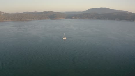 Aerial-view-of-Leisure-Boat-In-Sado-River,-Troia,-Portugal