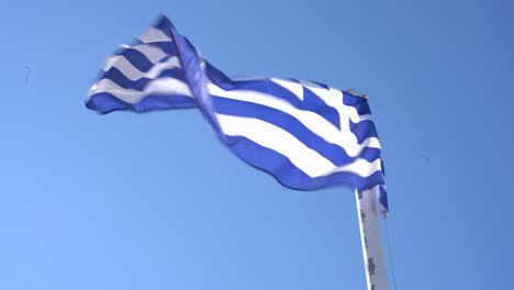 A-greek-flag-waving-in-the-harbor-of-Skiathos