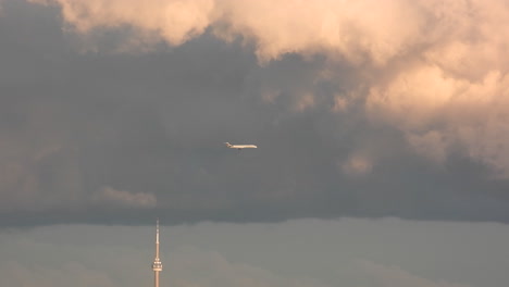 Moody-Overcast-Cloudy-Sky-with-Jetliner-Aircraft-Descending-to-Land-at-Airport-in-Toronto-Canada---Establishing-Shot