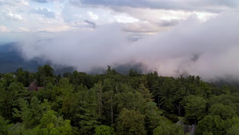 Treetop-aerial-view-of-clouds-and-fog-over-mountains-near-blowing-rock-nc
