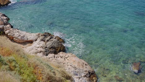 Waves-hitting-rocky-coast-of-Mediterranean-sea,-Kusadasi,-Turkey