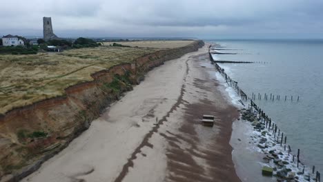 Aerial-footage-towards-Happisburgh-church-in-Norfolk-along-the-sea-defences-at-sunrise