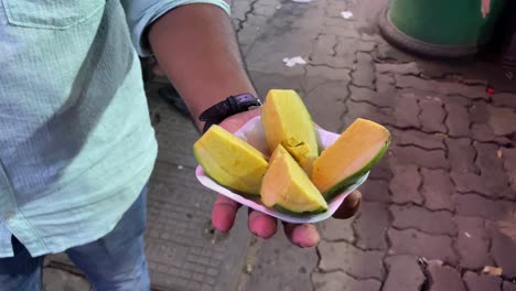 Video-of-a-man-enjoying-an-Indian-frozen-treat-called-a-mango-kulfi,-which-is-both-delectable-and-creamy