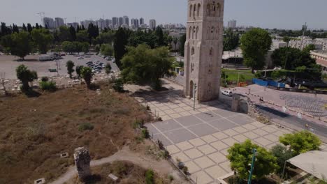 The-ruins-of-the-White-Mosque-in-Ramla,-Israel,-the-minaret-remains-still-standing,-surrounded-by-a-wide-square-and-some-ruins-of-houses-and-ancient-tombs-near-2