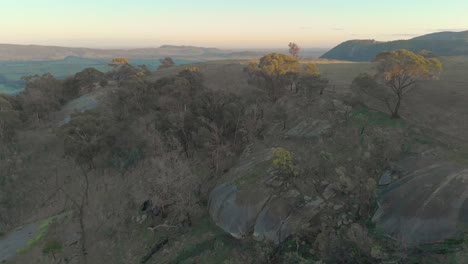 Aerial-shot-moving-forward-over-big-boulders-in-the-rolling-hills-of-the-strathbogie-ranges
