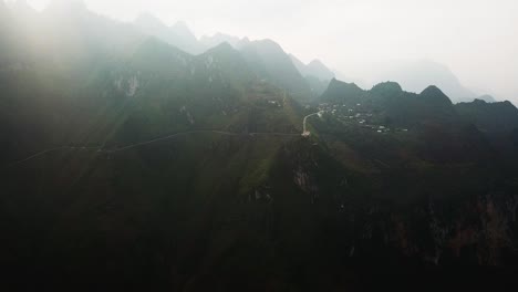 An-establishing-shot-shows-the-huge-mountains-that-make-the-Ma-Pi-Leng-Pass-through-steamy-fog-and-sunbeams