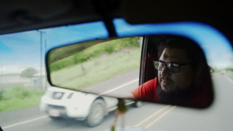 Latino-america-Costa-Rica-driving-on-the-highway-road-rear-view-mirror-view-of-touristic-driver