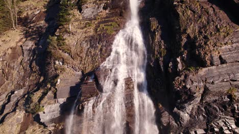 Aerial-drone-footage-raising-down-a-picturesque-waterfall-in-Grindelwald-in-the-Swiss-Alps
