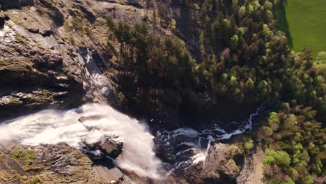 Aerial-drone-footage-top-down-view-rotating-counterclockwise-around-Fallbach,-a-picturesque-waterfall-in-Grindelwald-in-the-Swiss-Alps