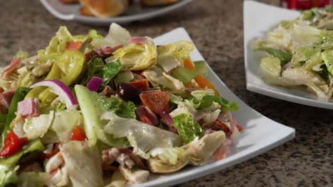 Two-Italian-chopped-salads,-dressed-salads,-slider-close-up-4K