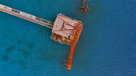 Rotating-top-view-Drone-Shot-of-a-Sugar-Cane-Pier-located-in-Aguadilla,-Puerto-Rico