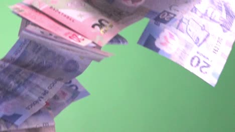 Mexican-bills-falling-in-slow-motion-on-a-green-screen