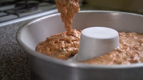 Pouring-Carrot-Cake-Dough-Mixture-Into-Tube-Pan-For-Baking