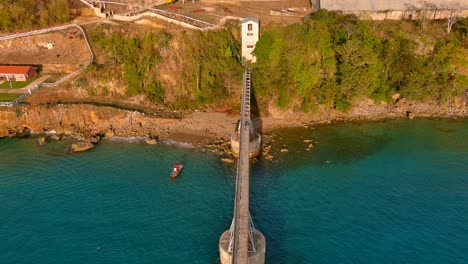 Zoom-out-Drone-Shot-of-a-Sugar-Cane-Pier-located-in-Aguadilla,-Puerto-Rico