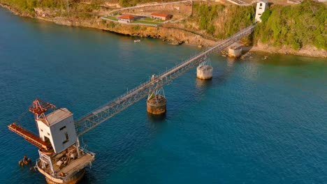 Full-View-Zoom-In-Drone-Shot-of-a-Sugar-Cane-Pier-located-in-Aguadilla,-Puerto-Rico