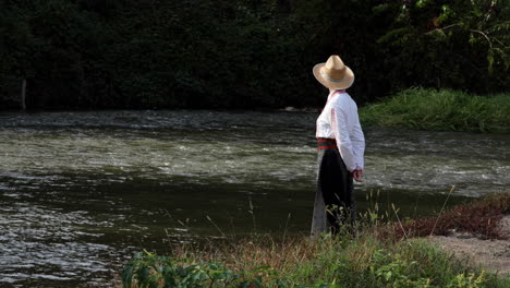 Romanian-girl-looks-at-the-water-from-the-river-bank-1