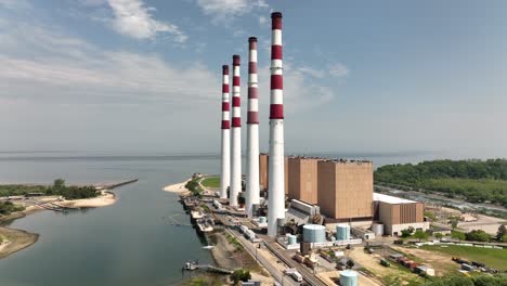 An-aerial-view-of-a-large-power-plant-on-a-sunny-day-with-blue-skies-and-white-clouds