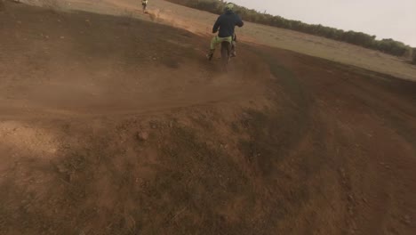 Dynamic-FPV-drone-follows-off-road-moto-rider-on-deep-sand-track
