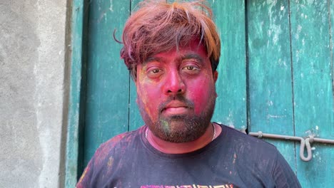 A-static-shot-of-a-boy-removing-mask-from-his-face-after-playing-Holi-in-front-of-camera