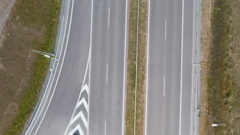Aerial-top-down-shot-of-empty-Road-in-sunlight-during-covid-19-pandemic