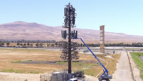 Industrial-Crane-Scaled-On-A-Tall-Cell-Site-During-Repair-Work-In-California,-USA