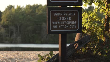 Swimming-Area-Closed-Signpost-On-The-Shore-Of-Atsion-Lake-In-Burlington-County,-New-Jersey,-USA