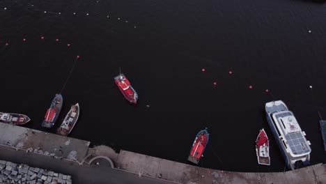 Fishing-boat-arriving-to-harbor-dock-top-down-aerial-drone-view,-Punta-del-Este-in-Uruguay