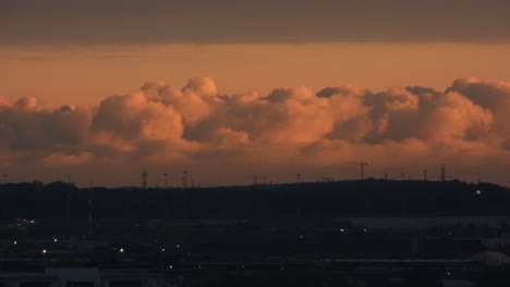 Beautiful-cloudscape-time-lapse-of-soft-and-fluffy-coral-color-clouds-movements-and-traffic-motions-at-sunset-golden-hours,-Toronto,-Canada
