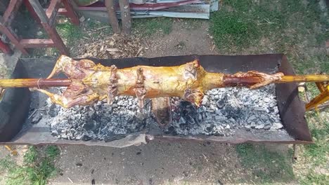 Lamb-on-a-pole-turning-above-hot-burning-logs-and-charcoal-2