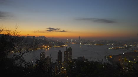 Cinematic-shot-of-the-bay-of-Hong-Kong-from-a-distant-hill-during-the-sunset