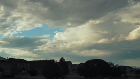 Suburban-neighborhood-at-dusk-with-the-homes-in-silhouette-and-a-dramatic-cloudscape-time-lapse-overhead