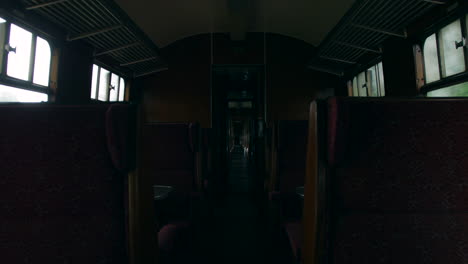 Travelling-in-an-empty-vintage-retro-railway-train-carriage-on-a-steam-engine-railway