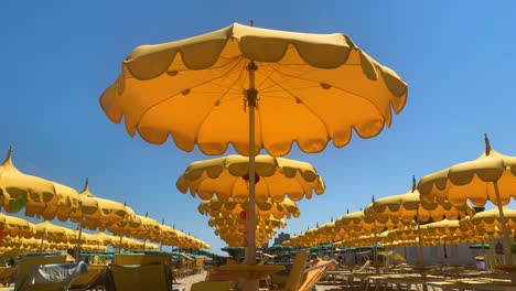 Rows-of-beach-umbrellas-open-against-clear-blue-sky-with-space-for-title