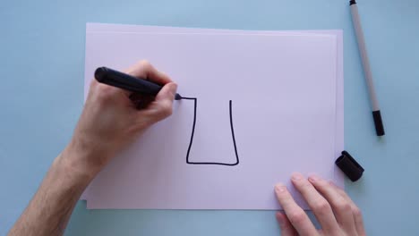 Drawing-an-arrow-pointing-upwards-on-a-piece-of-paper