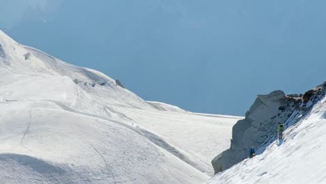 Dos-Montañeros-En-Travesía-En-Hielo-Con-Un-Fondo-Azul-En-Un-Día-Soleado,-En-El-Valle-De-Chamonix,-En-Francia
