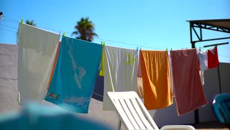 Beach-Colourful-Towels-Waving-On-Wind-Hung-Up-To-Dry-Outside