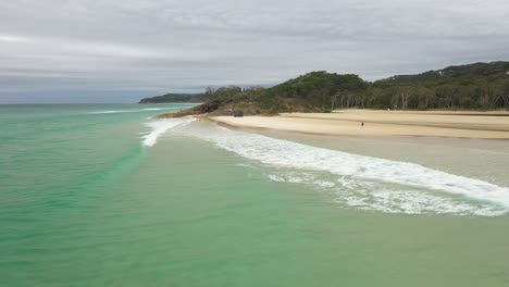 Travelling-view-over-small-waves-under-a-cloudy-sky-near-Stradbroke-Island-in-Queensland,-Australia