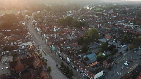 Rare-drone-shot-of-Henley-on-Thames-high-street,-panning-from-the-town-hall-down-to-the-bridge