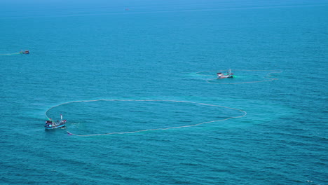 Vietnamese-fishing-vessel-with-massive-nets,-distance-aerial-view
