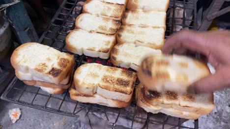 Ghee-butter-on-local-Bengali-plain-bread-baked-in-iron-grill-in-local-shop-in-Kolkata,-India