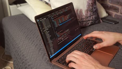 Hands-typing-on-a-keyboard-creating-a-web-based-computer-program-in-an-editor-on-a-laptop-computer
